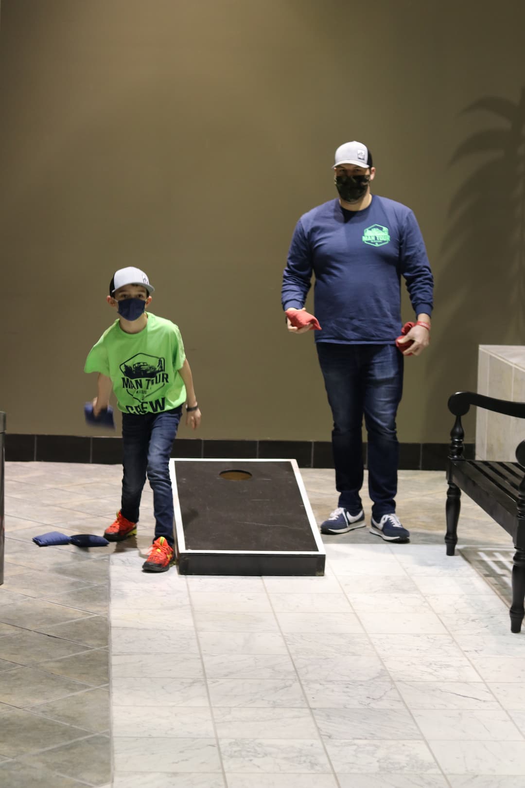 Father son playing cornhole at men's ministries event